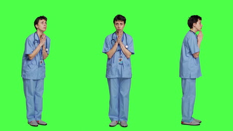 Medical-assistant-being-hopeful-praying-for-good-luck-against-greenscreen